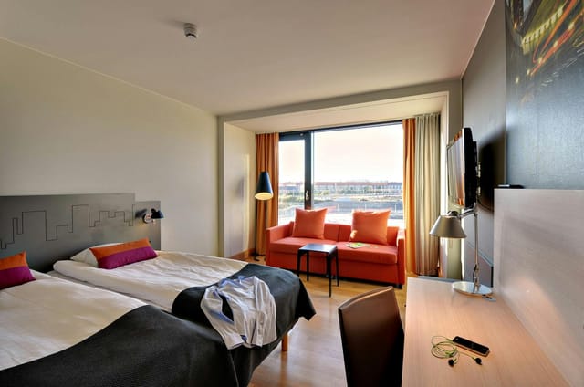 Scandic Sydhavnen guest room with workspace, ideal for corporate conference lodging.