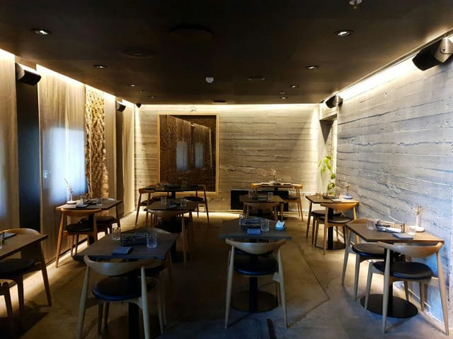 Modern private dining room at Herman K with concrete textures for VIP events and board dinners.