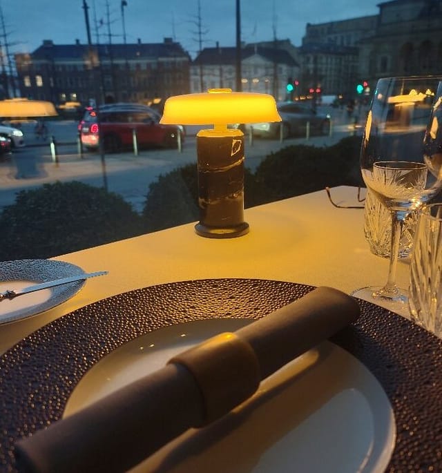 Elegant terrace table setting for intimate corporate dinner or VIP reception.