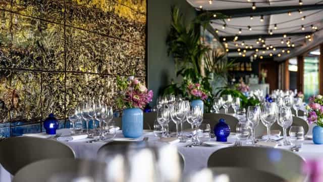 Upscale food hall dinner setup with blue accents for networking events and celebrations.