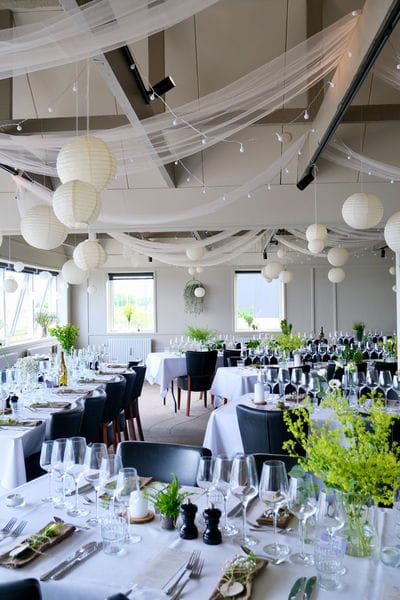 Budget-friendly Evarto restaurant venue with ceiling draping, lanterns, and minimalist decor.