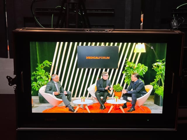 Virtual panel discussion setup with greenery backdrop for engaging events.