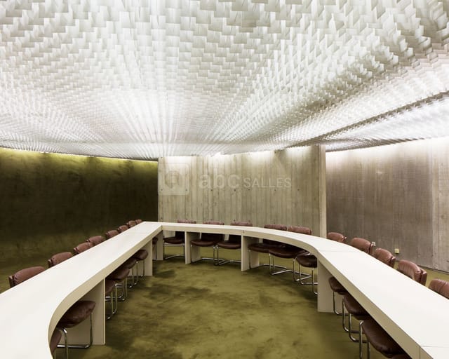 Espace Niemeyer Grand Hall boardroom with curved table for high-stakes meetings and conferences.