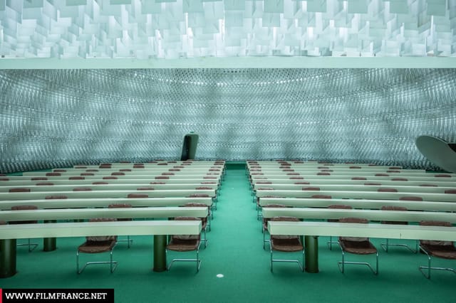 Espace Niemeyer auditorium with textured architecture for keynote conferences and business events.
