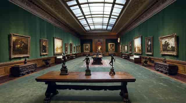 Frick Collection gallery for evening reception or gala dinner, elegant space with natural lighting.
