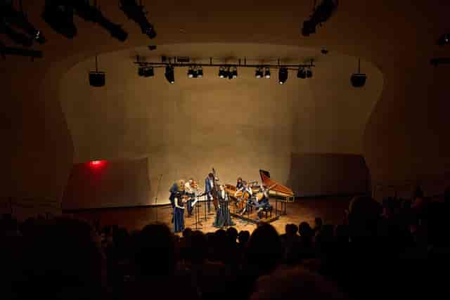Schwarzman Auditorium stage with warm lighting for intimate corporate event or luxury presentation.