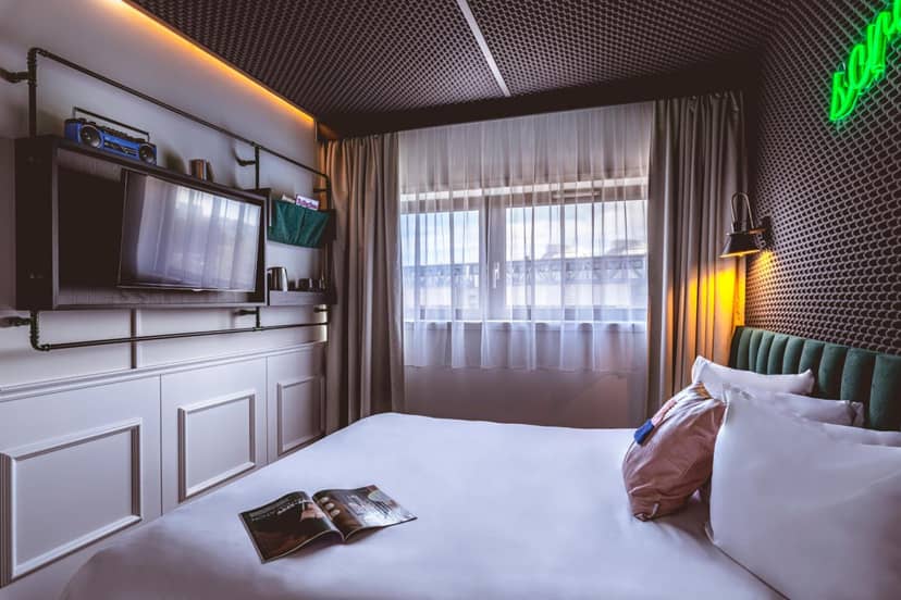 Industrial-chic coworking hotel room for corporate travel and business meetings.