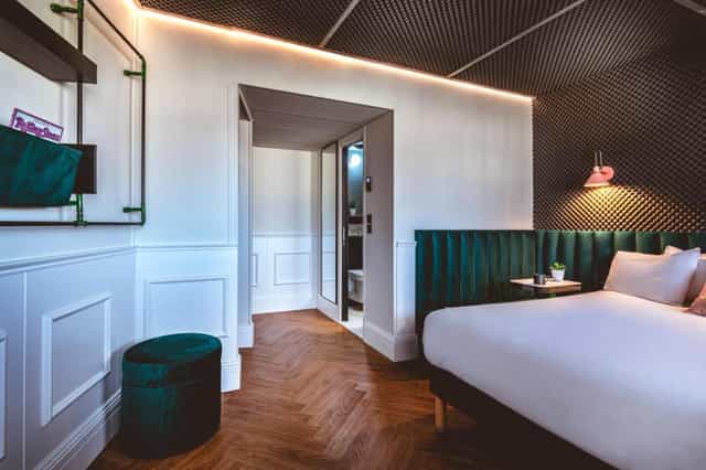Modern ReMIX Hotel coworking room with herringbone floors for boutique event and VIP lodging.