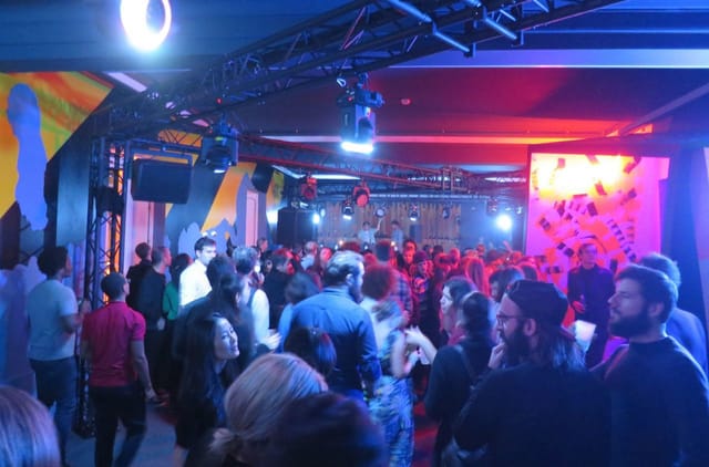 Graffiti-themed networking event at Salon Nijinski with industrial lighting for corporate parties.