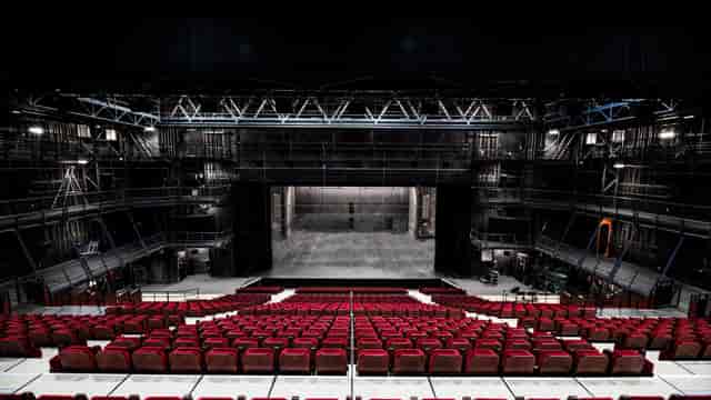 Salle Jean Vilar black-box theater with tiered seating for keynote events and stage productions.