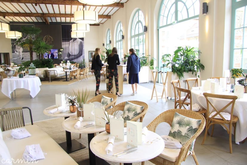 Orangerie d'Auteuil function room with bistro tables for elegant corporate events and receptions.