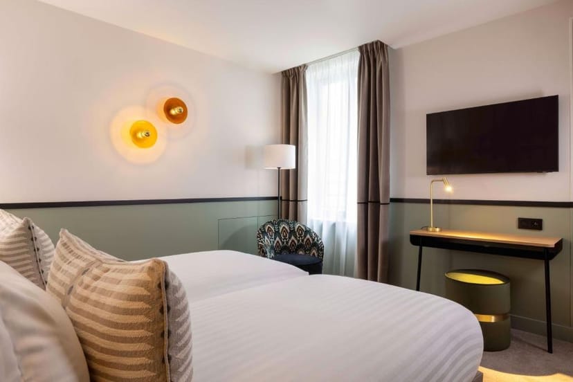 Modern hotel room with dedicated workspace for corporate business events and group travel.