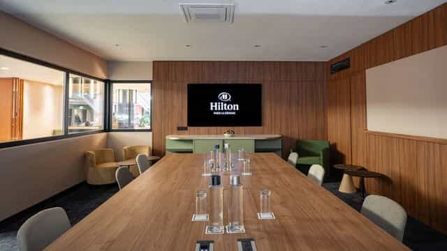 Modern Hilton Paris La Defense boardroom with AV tech for executive business meetings.
