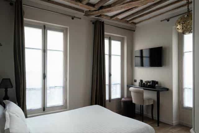 Boutique hotel room with desk for VIP offsite event accommodations and business travel.