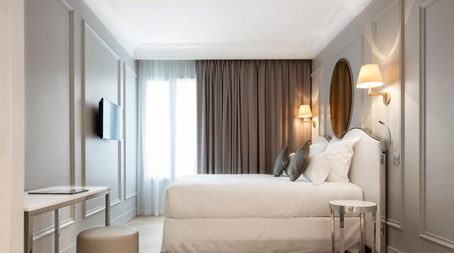 Modern guest room at Maison Pigalle hotel featuring a dedicated desk for business travel events.