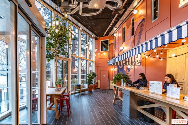 Event space at Porte de Versailles Hotel with floor-to-ceiling windows for networking and check-in.