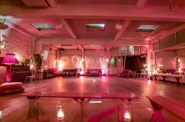 Industrial-chic Loft Lechapelais event space with pink ambient lighting for cocktail receptions.