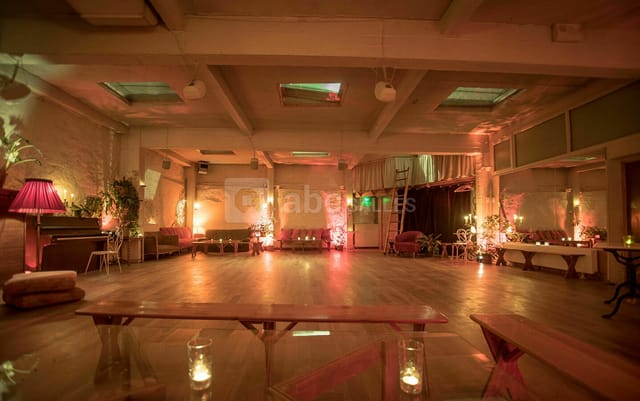 Industrial-chic loft dance hall with ambient lighting for networking events and cocktail receptions.