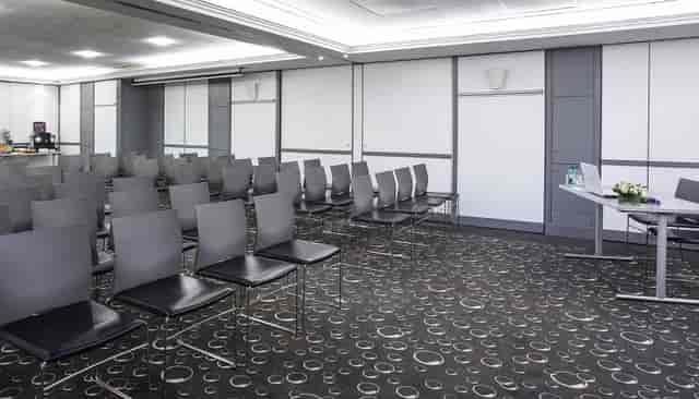 Meeting Room 4 theater setup with podium for professional business conferences and seminars.