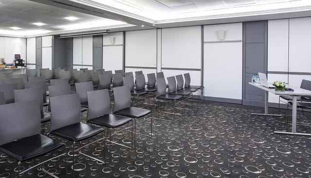 Meeting Room 4 theater setup with podium for professional business conferences and seminars.