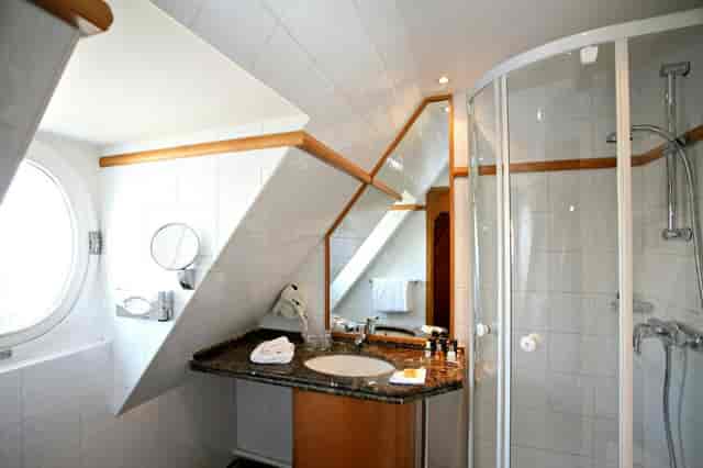 Attic-style boutique hotel meeting room with sloped ceilings for corporate events and workshops.