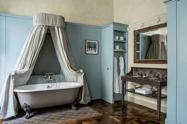 Luxury suite with dramatic curtained bathtub for VIP events and incentive travel.