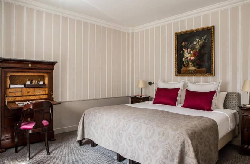 Luxury Hôtel des Saints Pères executive guest room with antique desk for business travel.