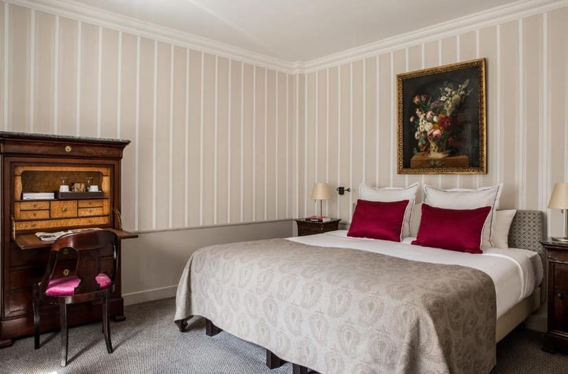 Luxury Hôtel des Saints Pères executive guest room with antique desk for business travel.