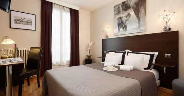 Hotel guest room with workstation for corporate business travel and event room blocks.