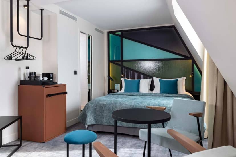 Modern hotel suite with workspace for business travel and event accommodation.