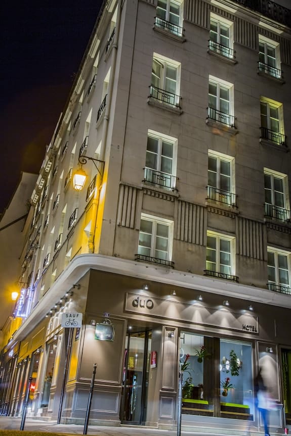 Hôtel Duo boutique hotel exterior with atmospheric evening lighting for luxury site visits.
