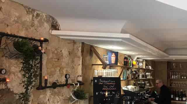 Rustic stone and industrial restaurant venue for networking mixers and welcome receptions.