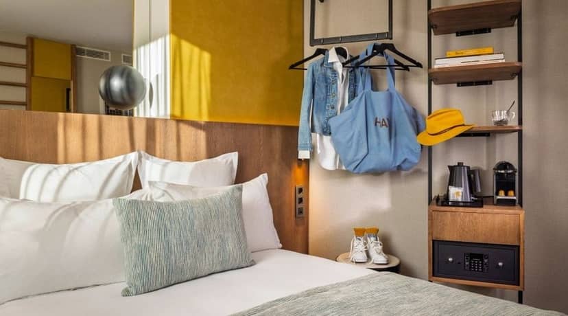 Modern hotel suite in Hôtel Raspail Montparnasse, compact design for urban business travel.
