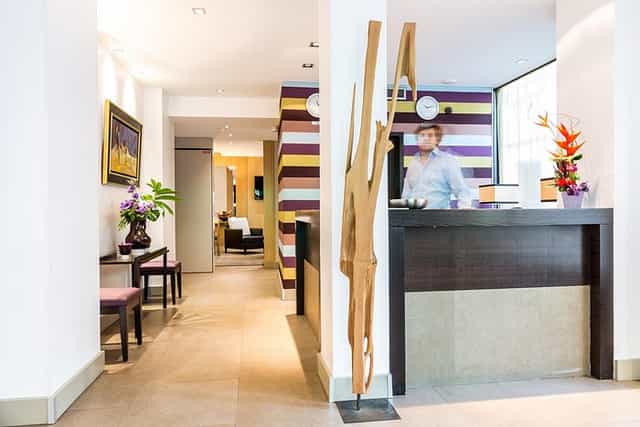 Boutique hotel lobby with low-profile reception desk for intimate event check-in and gatherings.