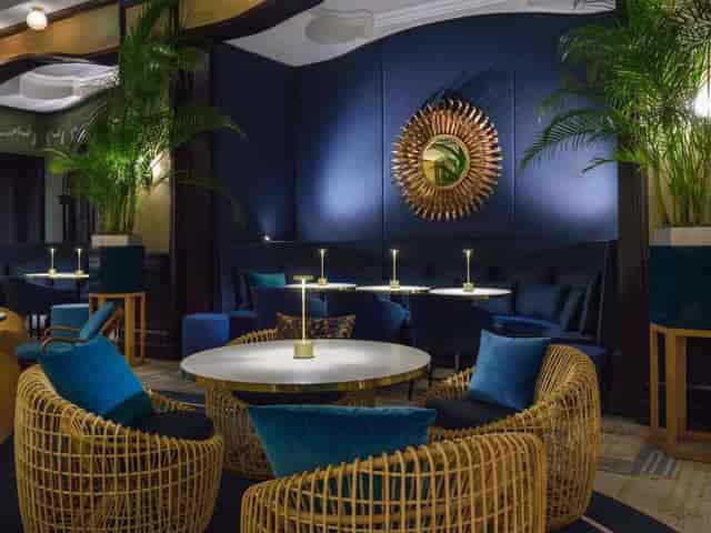 Salon Colbert lounge with navy decor for VIP receptions and corporate breakout sessions.