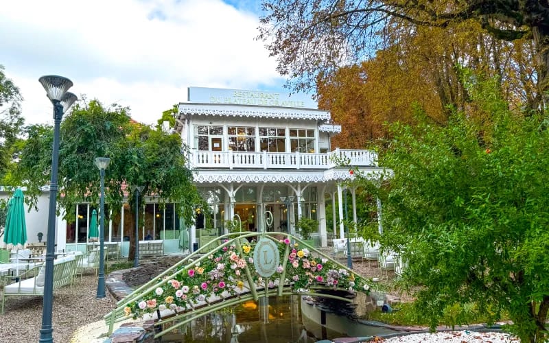 Le Restaurant venue with floral bridge for intimate garden wedding and boutique corporate retreat.