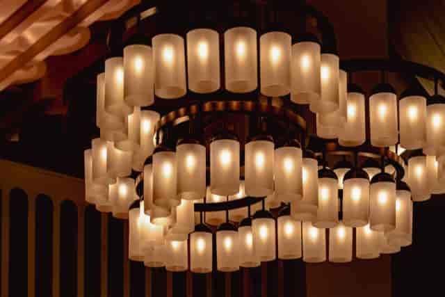 Multi-tiered chandelier in upscale ballroom lounge, perfect for luxury events and wedding venues.