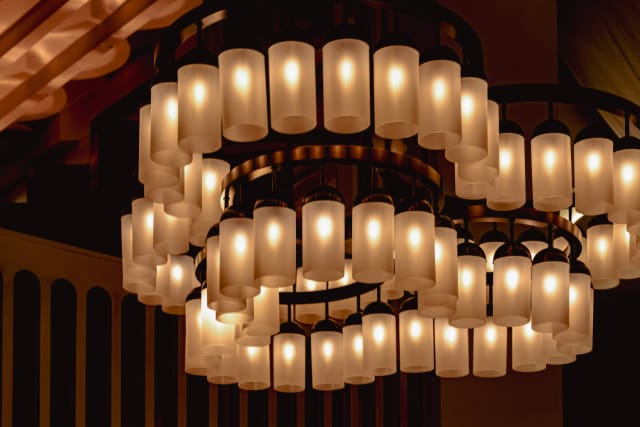 Multi-tiered chandelier in upscale ballroom lounge, perfect for luxury events and wedding venues.