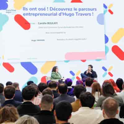 Fireside chat at Franchise Expo Paris: two speakers on stage engaging an audience.