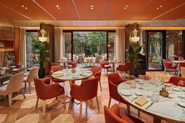 Bvlgari Hotel Paris private dining room with warm lighting for corporate dinners and receptions.