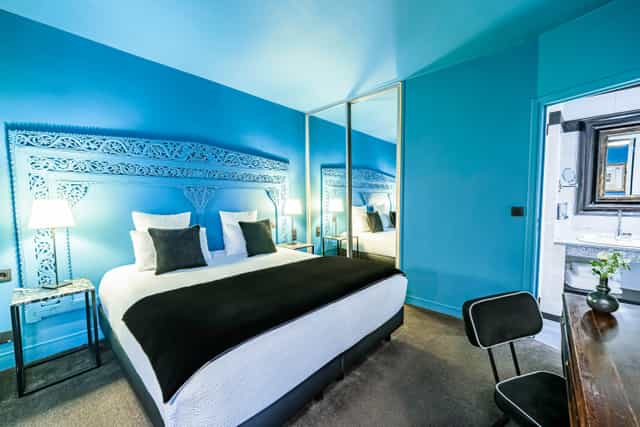 Boutique hotel room with bold monochromatic walls for luxury leisure and executive travel.