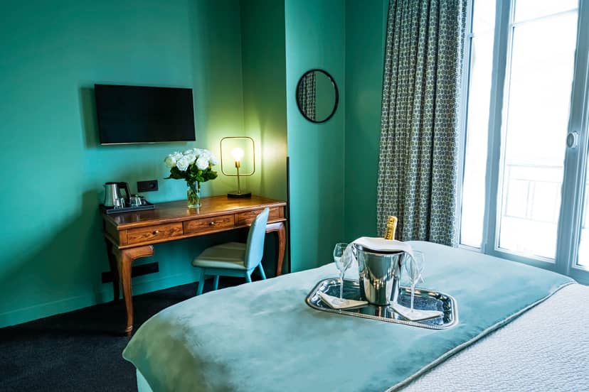 Boutique hotel room with executive workspace and amenities for business travel or corporate stay.