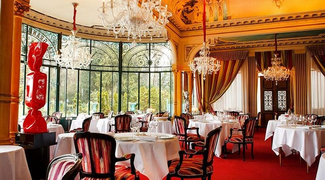 La Grande Cascade restaurant with ornate chandeliers for gala dinner or board meeting events.
