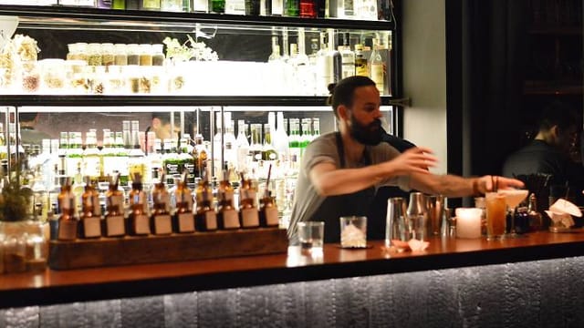 Illuminated bar at L’Herbarium for high-end networking reception and corporate event.