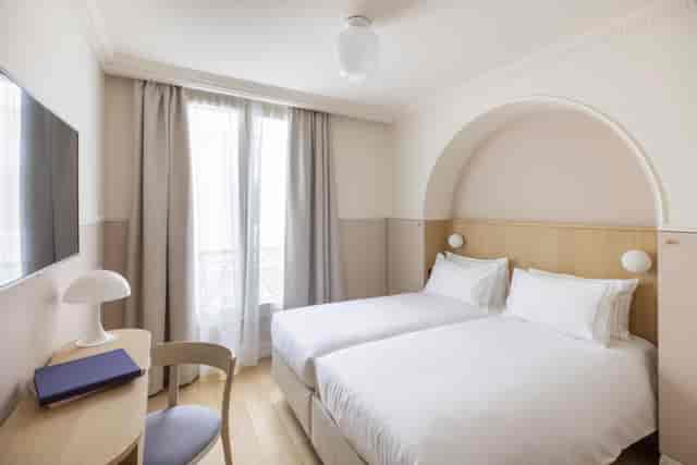 Modern twin-share hotel room for conference accommodation and business travel.
