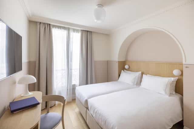 Modern twin-share hotel room for conference accommodation and business travel.
