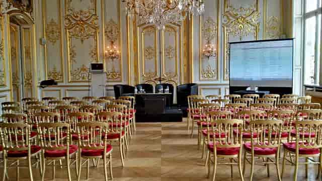 Gilded Salon Lafayette ballroom with theater seating for corporate events and luxury conferences.