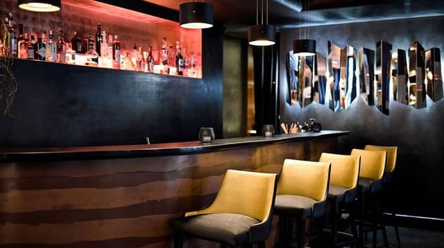 Sophisticated The One Alma Paris bar with moody lighting for VIP networking and B2B events.