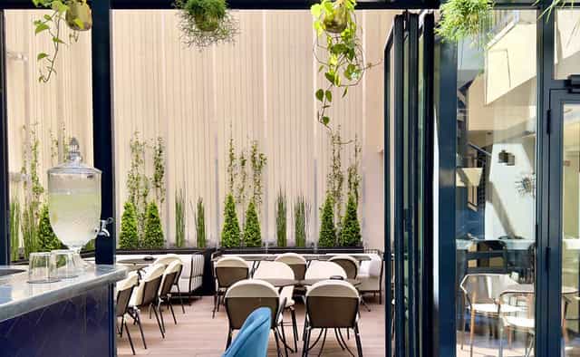 Restaurant Quantième terrace with vertical greenery for corporate networking and social events.