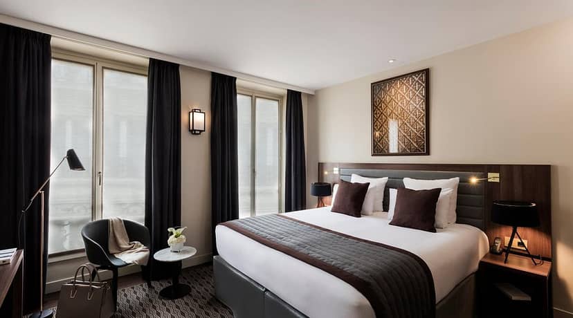 Modern hotel suite with seating area for corporate travel and luxury business events.